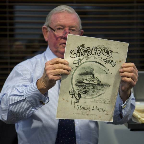 Peter holding up the sheet music.